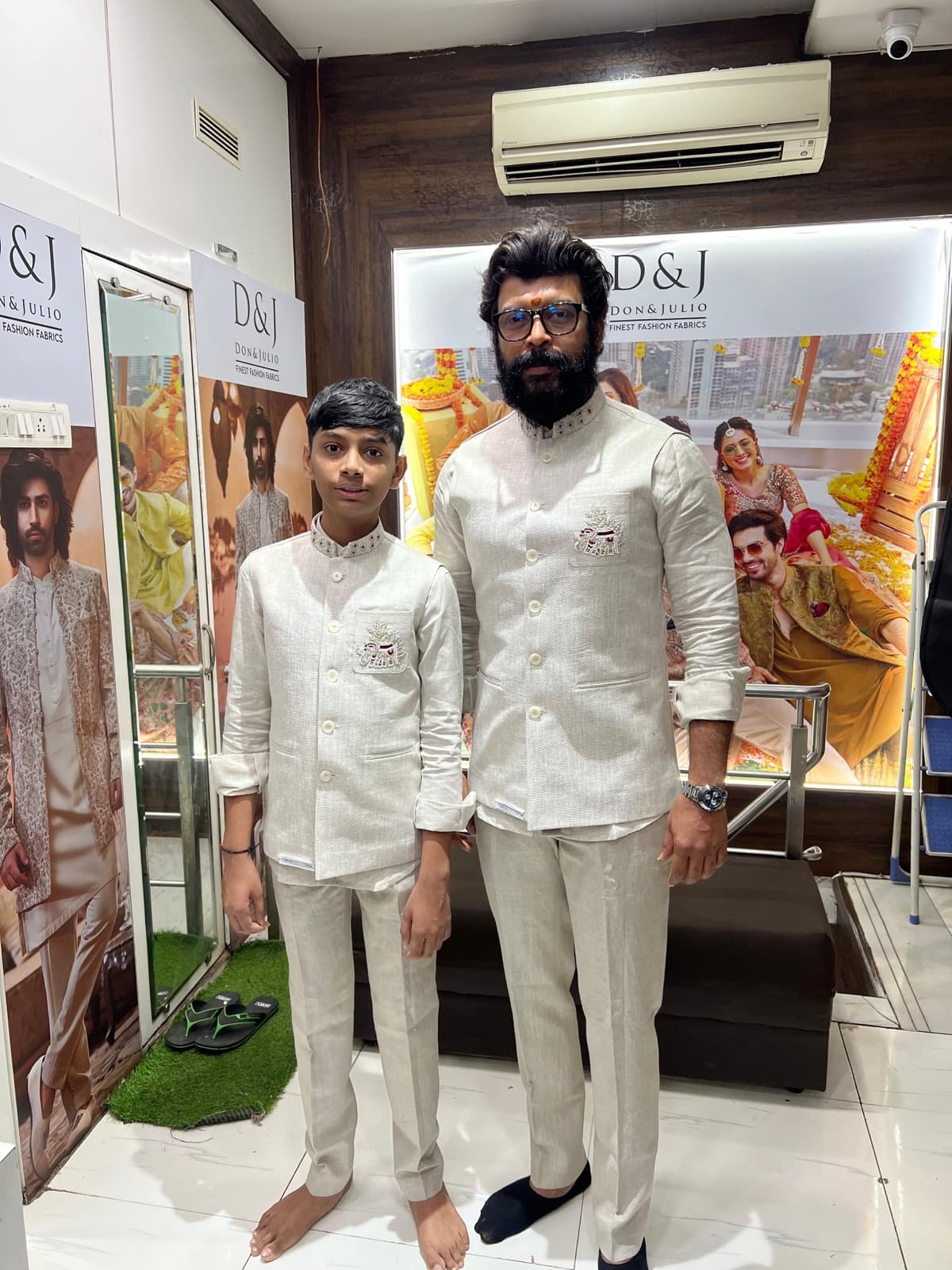 Father and son in matching tailored ivory sets