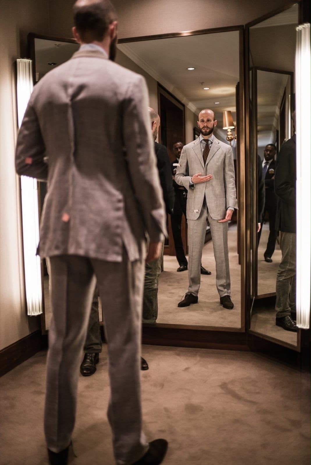 Client checking the fit of his suit in the mirror