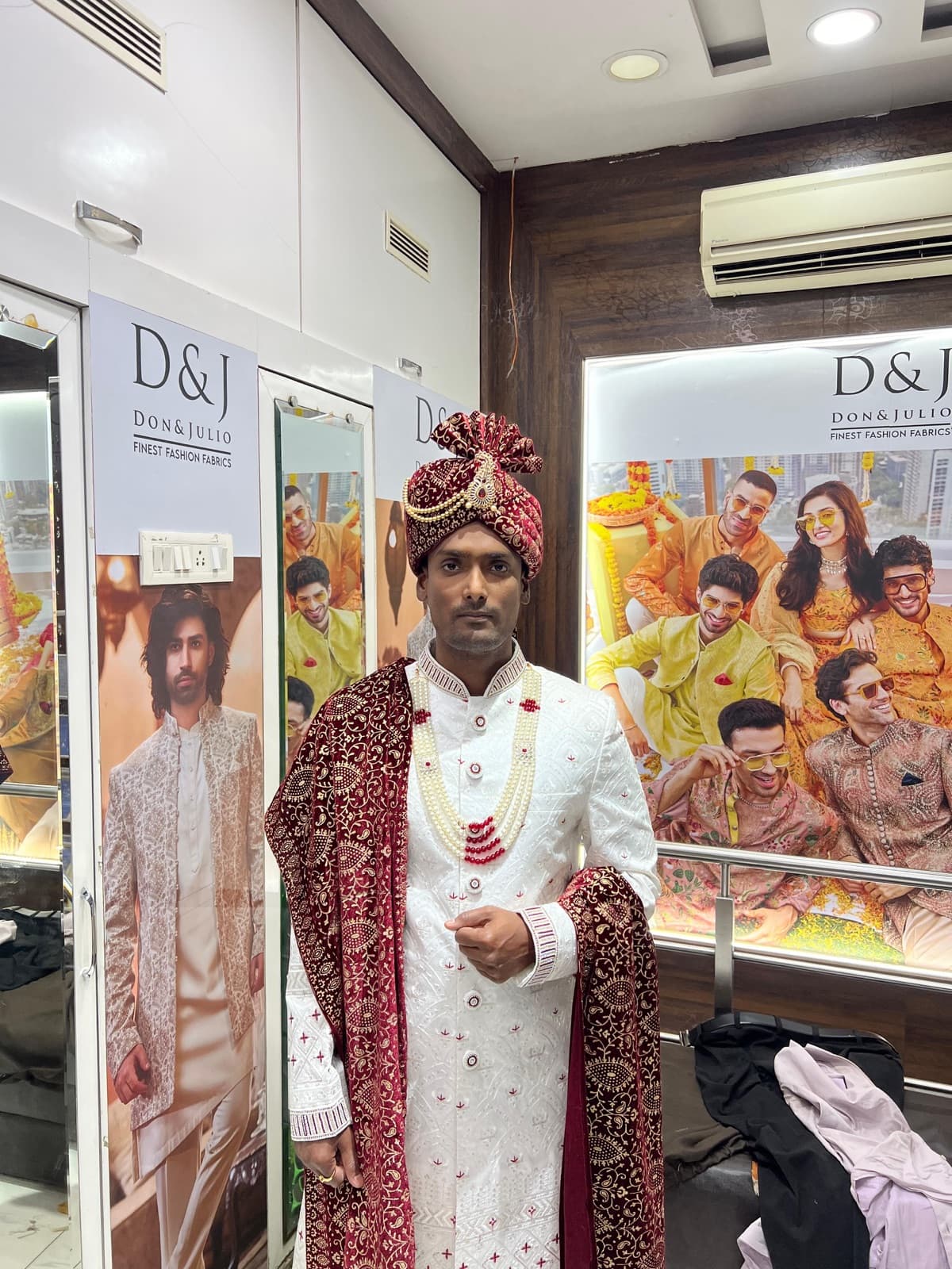 Groom in ivory sherwani with maroon dupatta and safa